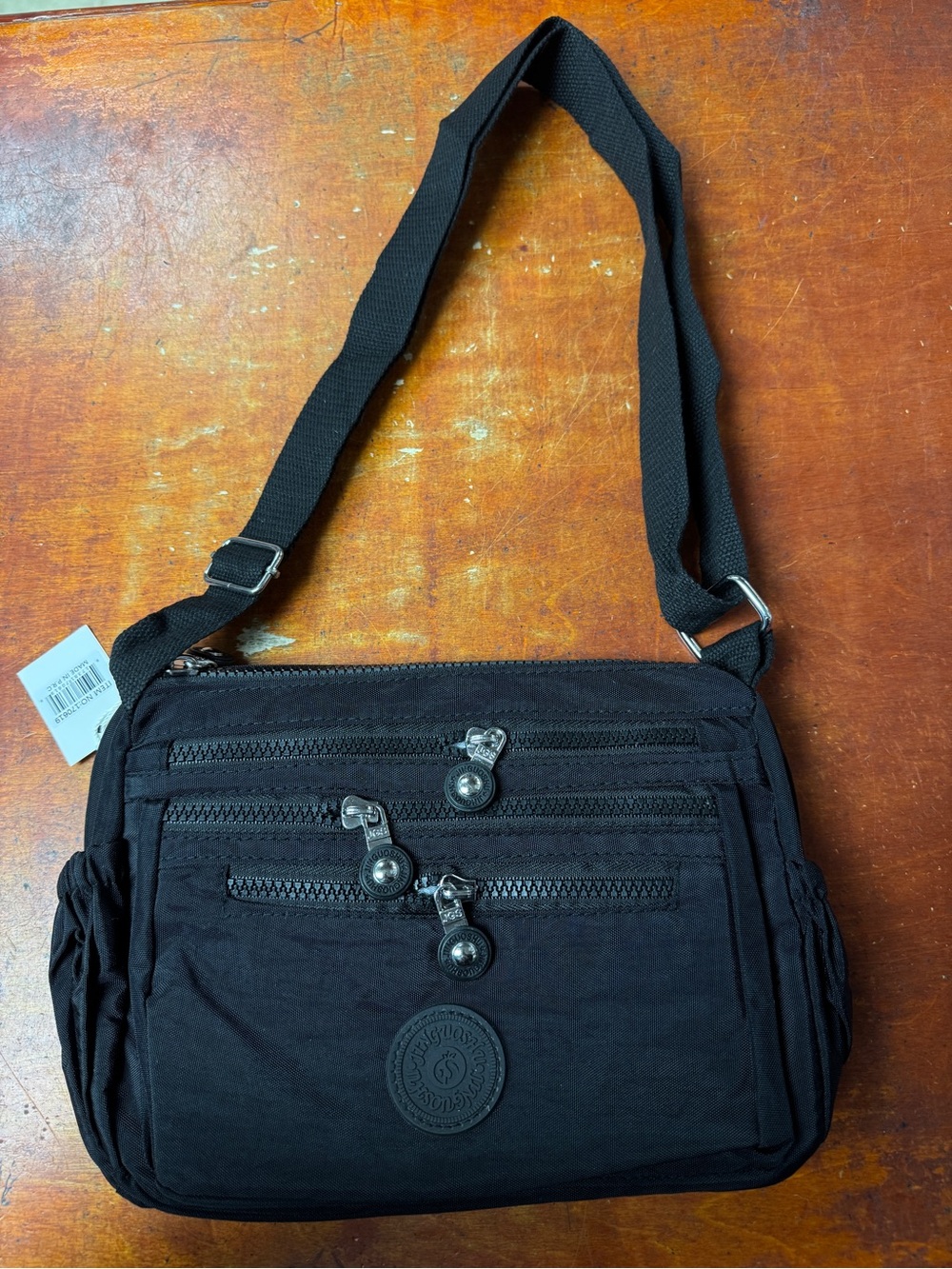 Compact Black Shoulder Bag with Multiple Zip Pockets